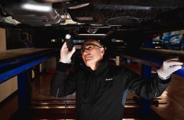 Kwik Fit technician, working on car, 2024, working on car